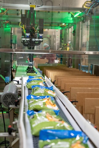 Soules Foods' nuggets enter EVO for dual-pick, vision-guided case loading.