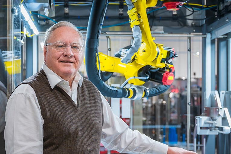 CEO Dale Andersen stands in front of a Delkor machine