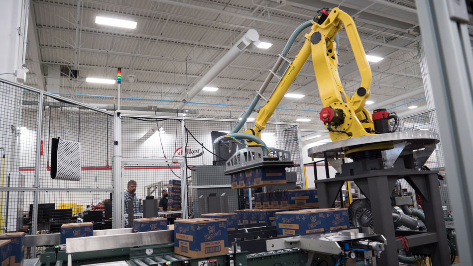 Palletizer in action picking up RSC cases for stacking Palletizer in action picking up RSC cases for stacking
