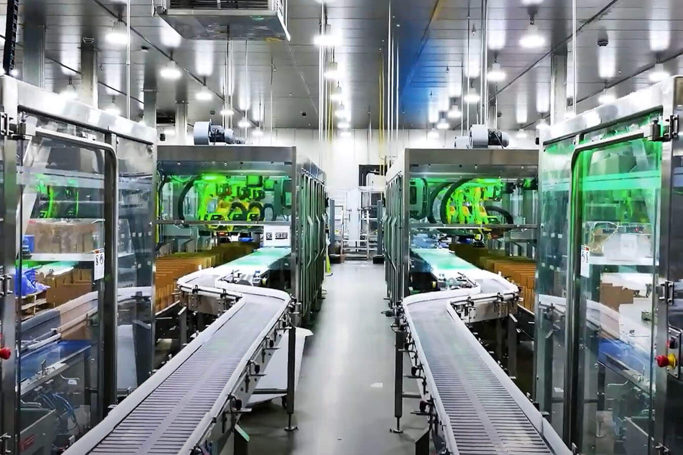 A photograph of two packaging equipment lines side by side