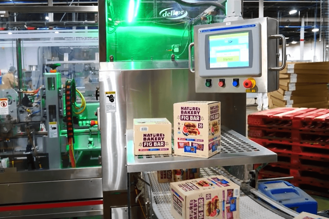 Nature's Bakery cartons sit on a Delkor carton and case closer